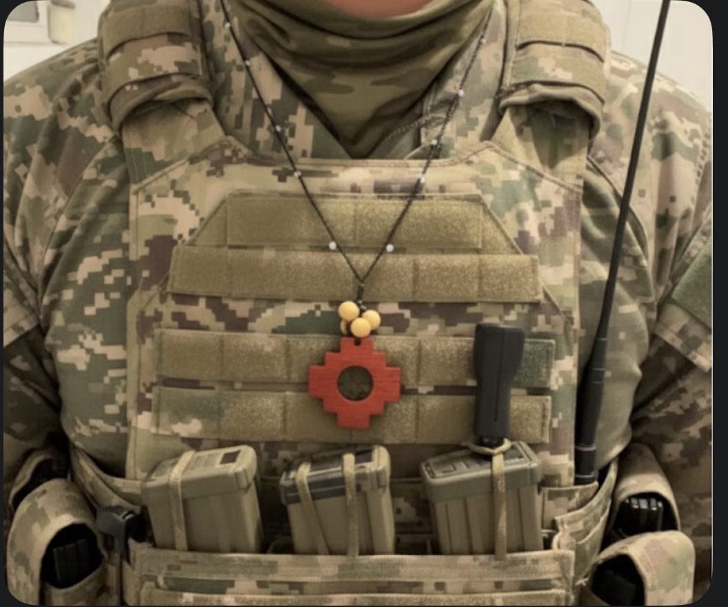 Soldier wearing Chakana necklace over plate carrier